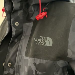 North Face rain jacket, black camo with red detail. Size small.